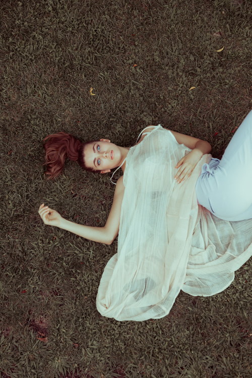 Stock Photo Girl lying on the grass looks at the sky free download