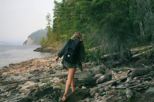 Stock Photo Girl walking barefoot on the beach