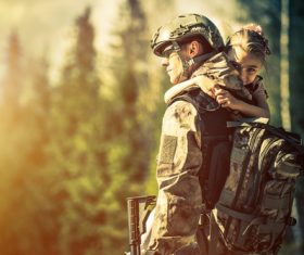 Stock Photo Holding the little girl soldier