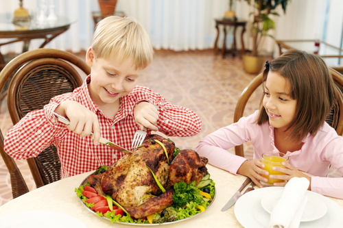 Stock Photo Little boy eating turkey