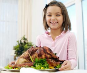 Stock Photo Little girl holding festive sultry turkey