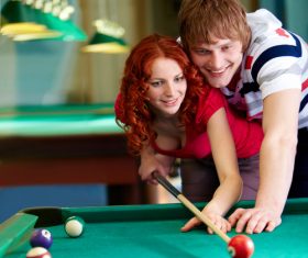 Stock Photo Teach girlfriend to play billiards