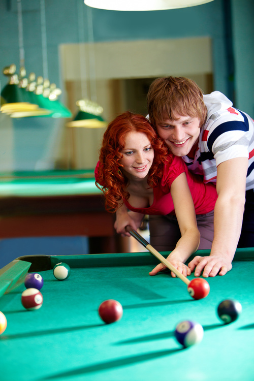 Stock Photo Teach girlfriend to play billiards