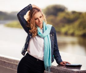 Stock Photo Woman standing on the bridge combing hair