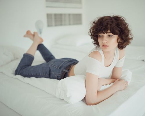 Stock Photo Young girl lay on bed