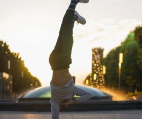 Street dance handsome one-handed inverted support Stock Photo