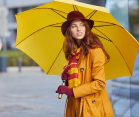 Woman holding up an umbrella on the street Stock Photo
