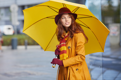 Woman holding up an umbrella on the street Stock Photo
