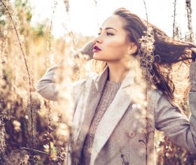 Woman in autumn outdoor pose taking photo Stock Photo