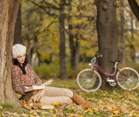 Woman reading a book under the tree in autumn Stock Photo 02