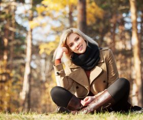 Woman sitting on the grass Looking At Camera Stock Photo