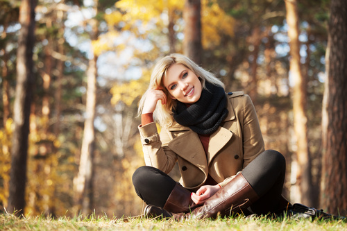 Woman sitting on the grass Looking At Camera Stock Photo