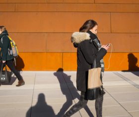 Woman walking looking at mobile phone Stock Photo