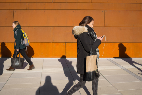 Woman walking looking at mobile phone Stock Photo