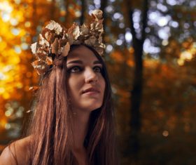 Woman wearing a wreath of withered leaves Stock Photo