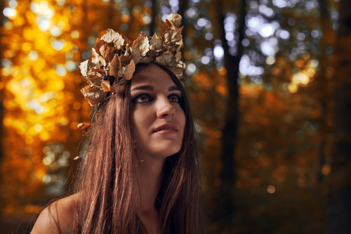 Woman wearing a wreath of withered leaves Stock Photo