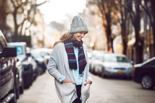 Woman wearing warm clothes on autumn street Stock Photo