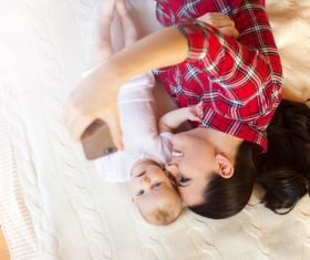 Young mother taking care of baby at home Stock Photo 01