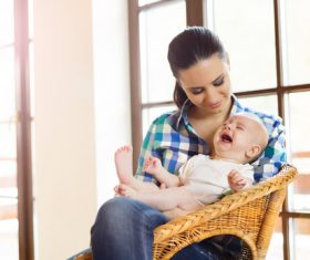 Young mother taking care of baby at home Stock Photo 02