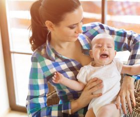 Young mother taking care of baby at home Stock Photo 03