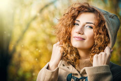 Young woman wearing a hooded coat Stock Photo