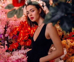 Beautiful Asian girl posing in the flowers Stock Photo