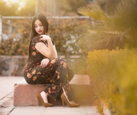 Beautiful female model wearing black floral dress Stock Photo