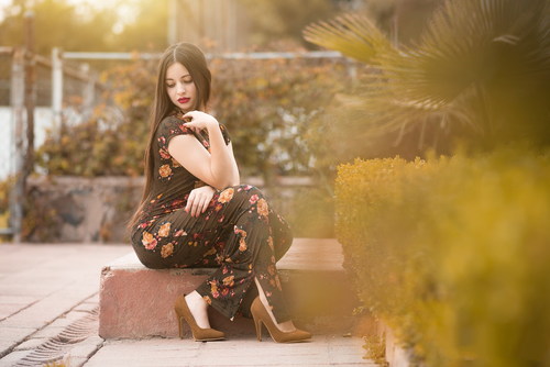 Beautiful female model wearing black floral dress Stock Photo