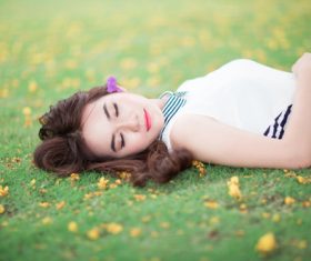 Belle lying on the grass and sleeping Stock Photo