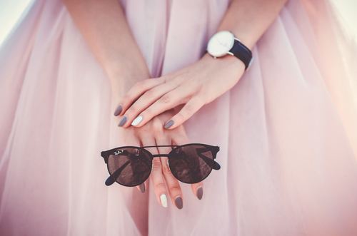 Closeup of woman holding sunglasses in hand Stock Photo