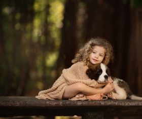 Cute little girl holding puppy Stock Photo