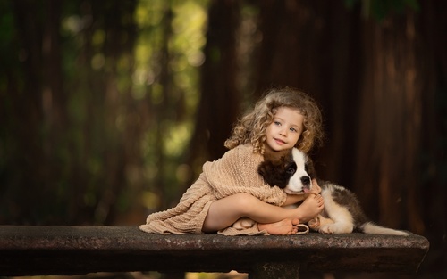 Cute little girl holding puppy Stock Photo