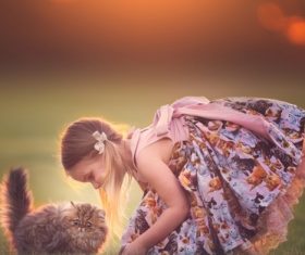 Cute little girl playing with cat Stock Photo