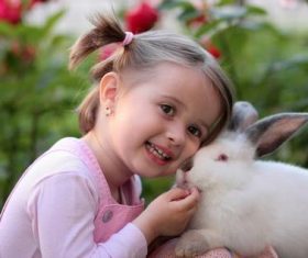 Cute little girl with white rabbit Stock Photo