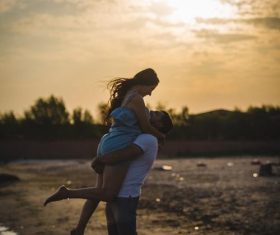 Dusk beach couple Stock Photo