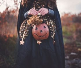 Girl holding pumpkin light Stock Photo