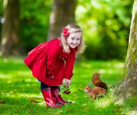 Little girl feeding a squirrel Stock Photo