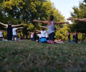 People practicing yoga in the park Stock Photo