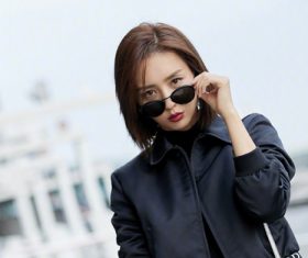 Pretty woman taking off sunglasses Stock Photo
