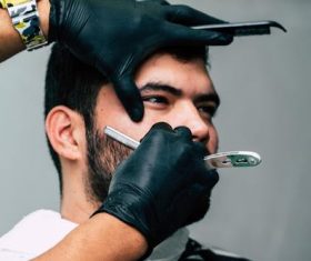 Professional barber shaves the customer Stock Photo 01