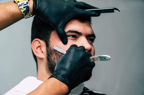 Professional barber shaves the customer Stock Photo 01