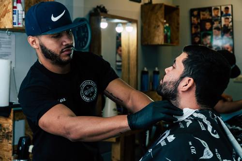 Professional barber shaves the customer Stock Photo 02