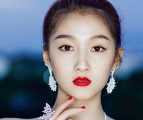 Stock Photo Asian girl wearing jewelry earrings