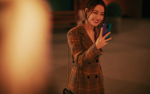 Stock Photo Beautiful girl holding a mobile phone selfie