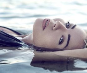 Stock Photo Closeup of woman lying in the water