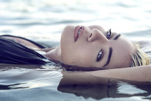 Stock Photo Closeup of woman lying in the water