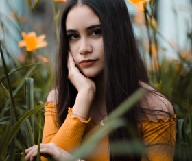 Stock Photo Girl posing with yellow flowers