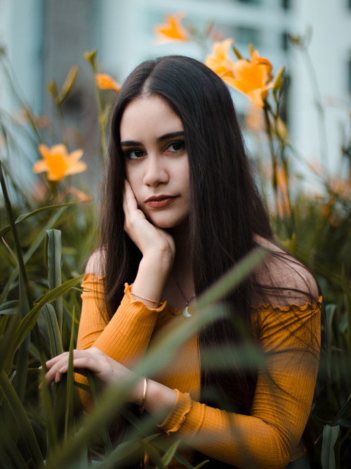Stock Photo Girl posing with yellow flowers