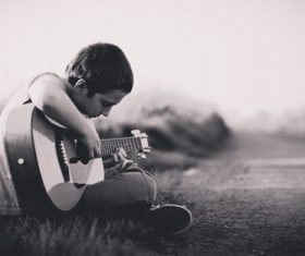 Stock Photo Little boy playing guitar