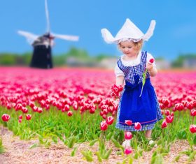 Stock Photo Little girl standing in front of pink flower field